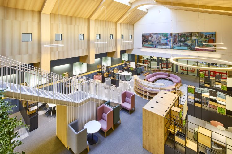 Photo of the Collaborative Learning Area in Health Sciences Library taken from the mezzanine floor looking down at the bottom floor.