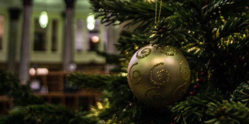 Close-up of a gold bauble on the Christmas tree with the Brotherton Library in the background