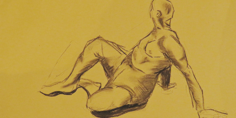 A life drawing sketch, of a man sat down with his legs stretched out