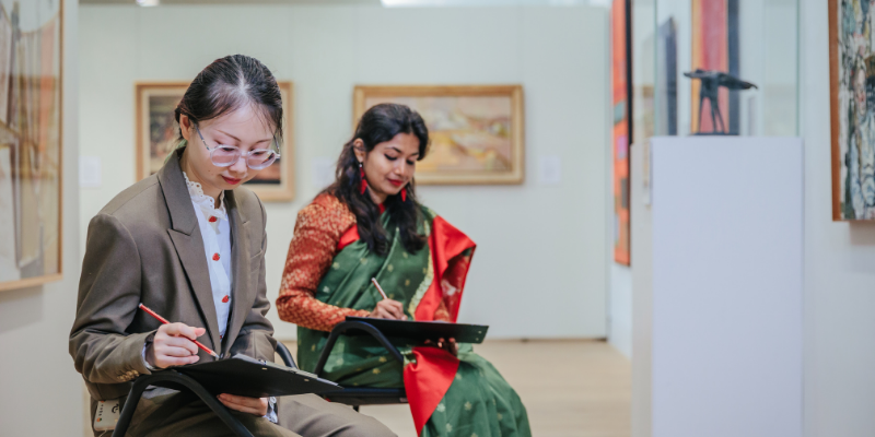 Visitors sketching in the art gallery