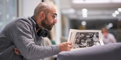Artist Mohammed Barrangi flicking through a book of designs.