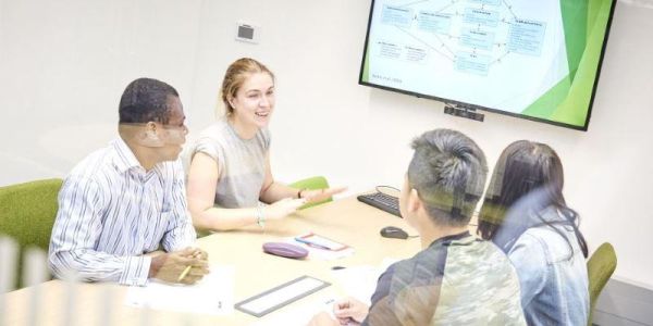 Students working as a group around a table