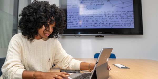 A student working at a laptop in the Library