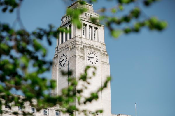 Parkinson Building, a large white clock tower, against a clear blue sky.