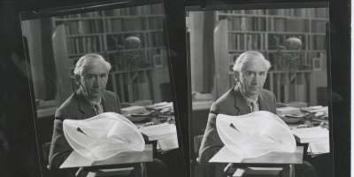 A black and white image of Herbert Read in his study at Stonegrave House with Naum Gabo’s Linear Construction II, c. 1960s.